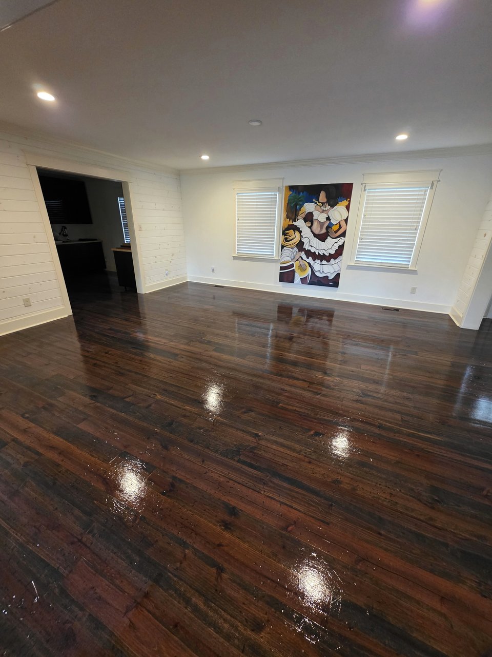 Reflective dark wood floor in an open room