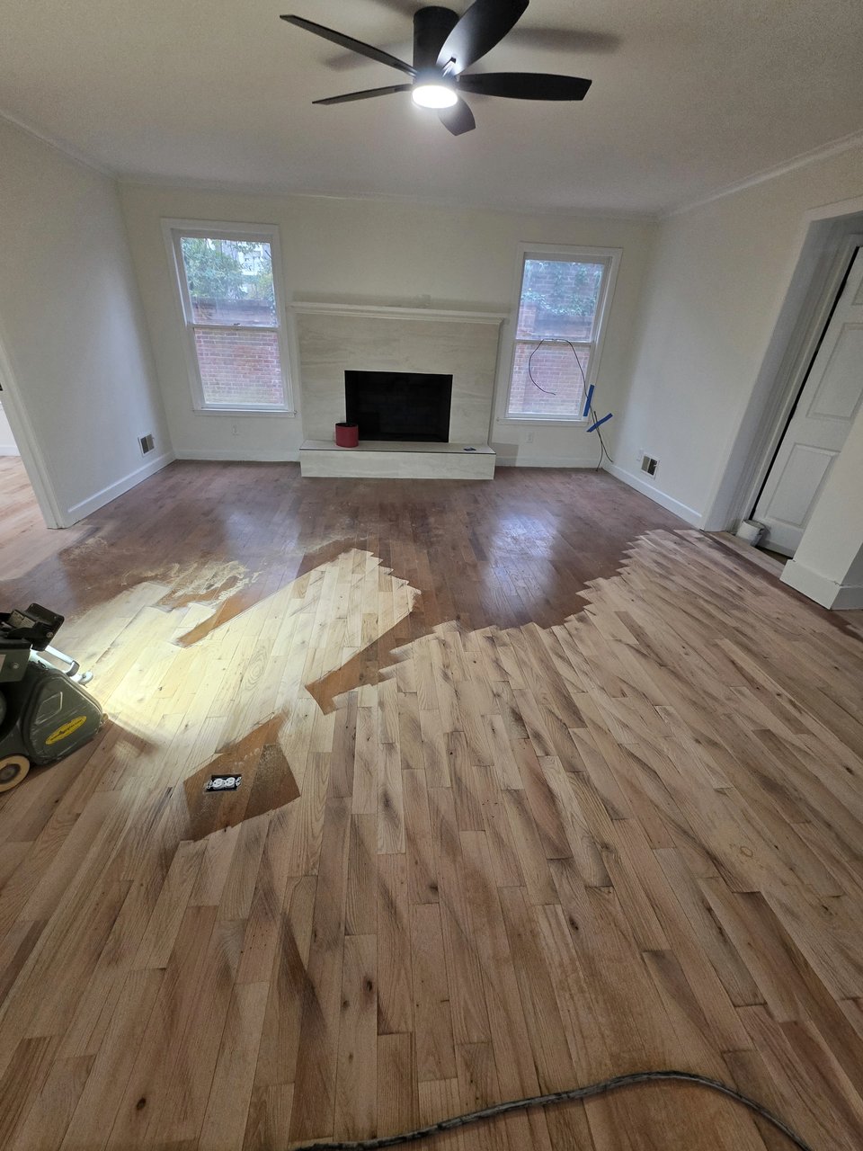 Wood floor with areas sanded back during preparation